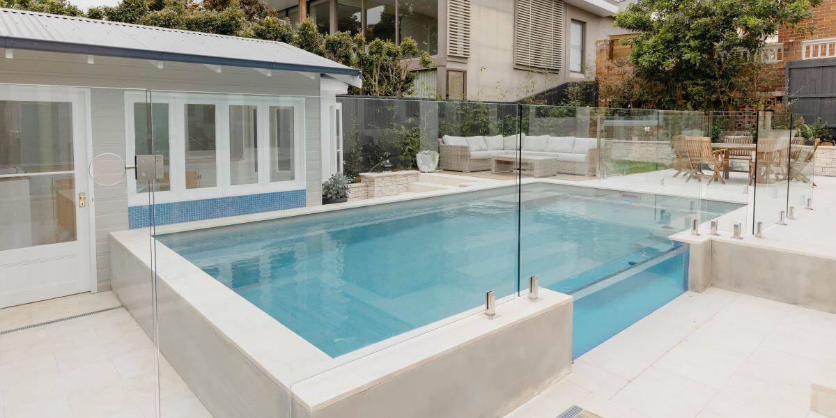 7.2m X-Trainer in colour Quartz showcasing glass pool fencing. Pool installed by Compass Pools Sydney. Compass Pools Australia 7.2m X Trainer Quartz Compass Pools Sydney
