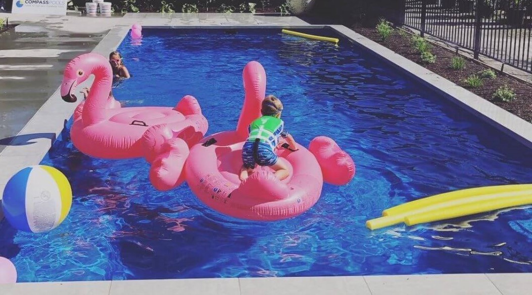 X Trainer 10.2m in colour Pacific with pool toys. Pool installed by Compass Pools Christchurch. Compass Pools Australia X Trainer 10.2m Pacific CPC