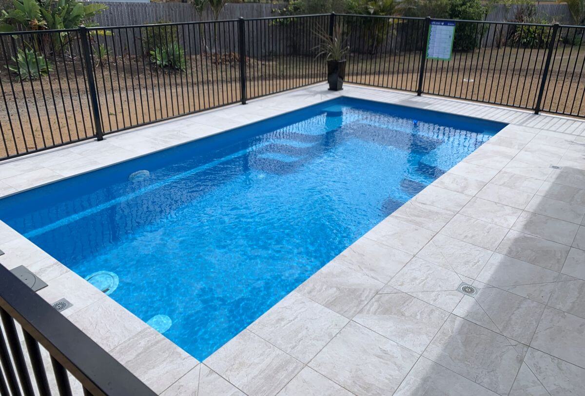 5.8m X Trainer in colour Sapphire with aluminium fencing. Pool installed by SJs Pools & Spas. Compass Pools Australia X-Trainer 5.8m Sapphire SJs Pools