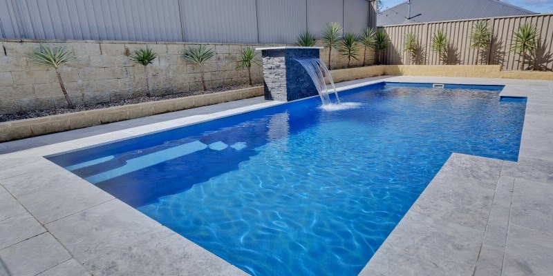 Compass Pools Vogue swimming pool shape with a water wall feature Compass Pools Vogue swimming pool shape with a water wall feature